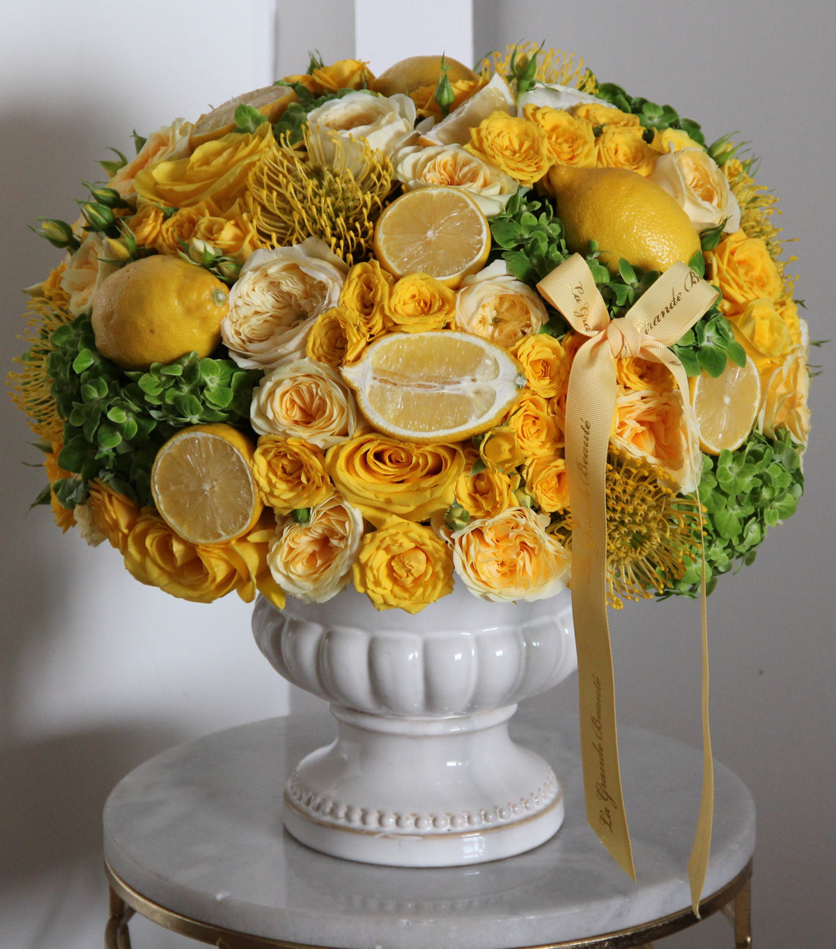 “Sicily” – yellow and green arrangement with citrus fruit by La Grande Beauté, luxury flower delivery London