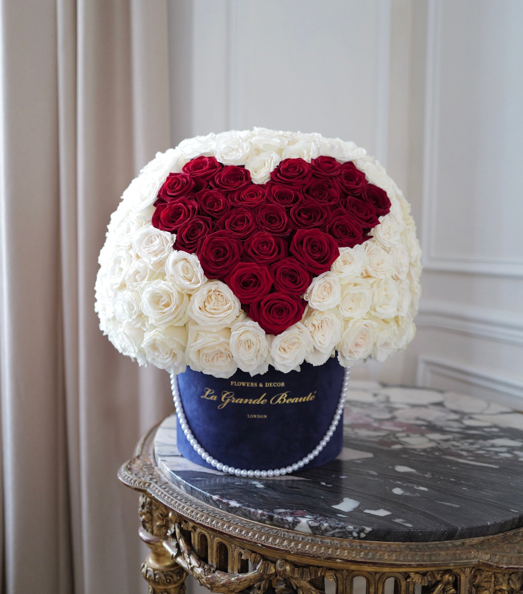 “La Grande Romance” – heart box of 100 red and white roses by La Grande Beauté, luxury flower delivery London