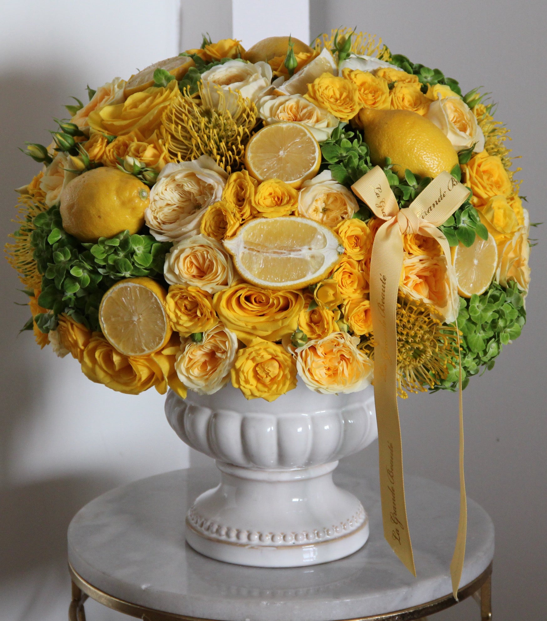 “Sicily” – yellow and green arrangement with citrus fruit by La Grande Beauté, luxury flower delivery London