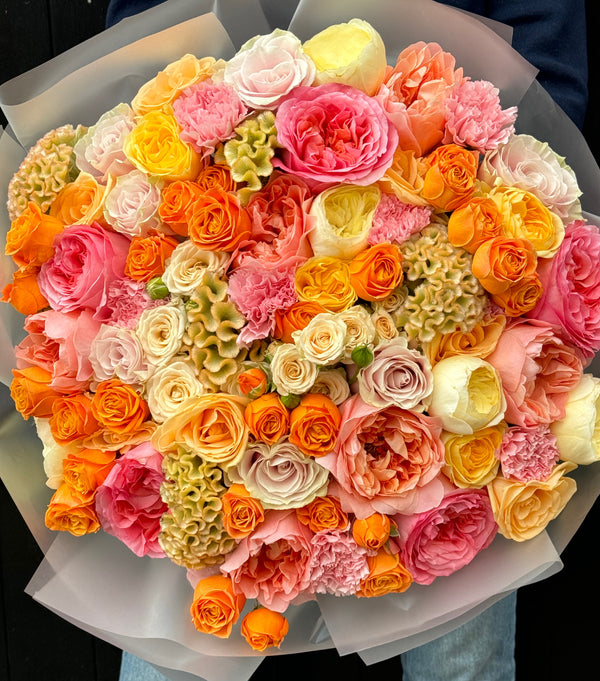 Bouquet of colorful flowers including roses and hydrangeas.