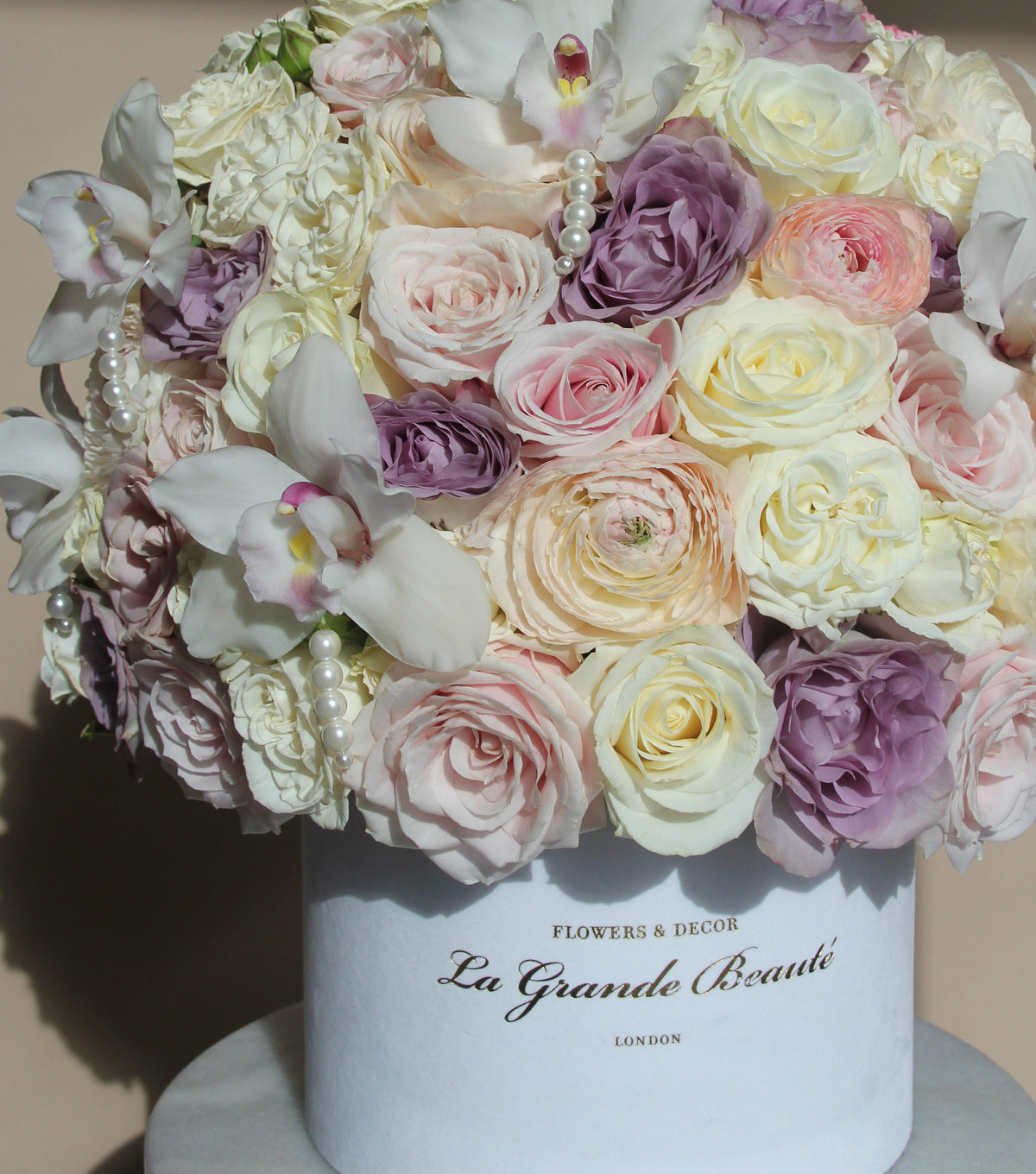 “Shimmer” – rose, ranunculus and pearl orchid velvet box by La Grande Beauté, luxury flower delivery London