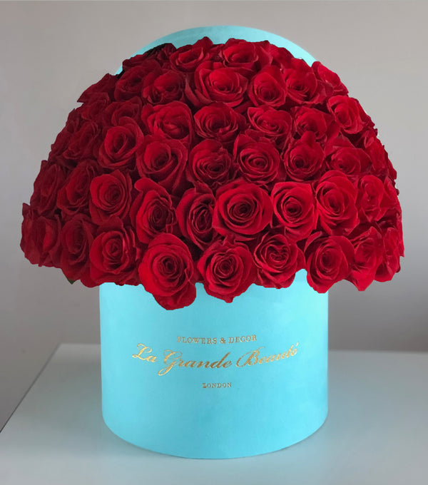 Fresh red roses placed into a blue velvet La Grande Beaute Box. The box can Contain 50, 75 or 100 roses depending on your choice.