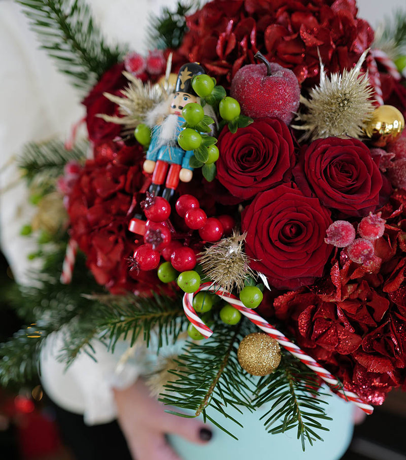 ''Nutcracker'', freshflowerbox, La Grande Beaute, christmas, Fresh, Welcome the charm of the season with ' Nutcracker''. Create a festive mood at your home or gift a Christmas Spirit to your loved ones. Hydranges, roses, hypericum berries and other greenery and ornaments are used to make this beautiful design. The arrangement in the photo is in the blue 25cm size La Grande Beaute velvet box. Central London Delivery Only. Please check our shipping policies for postcodes. DISCLAIMER - FRESH FLOWER