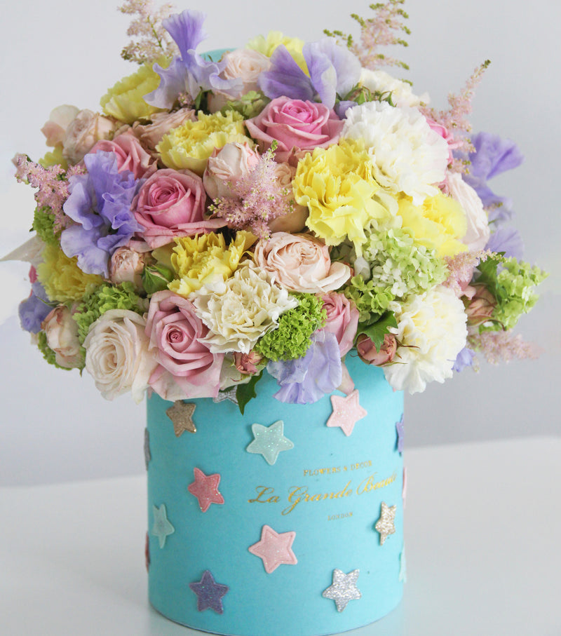 ''Etoile'', freshflowerbox, La Grande Beaute, Fresh, petite, Make someone's day magical with the fresh flower box "Etoile". Filled with pastel color flowers and decorated with star embellishments, this arrangement simply takes the breath away. The arrangement in the photo is in a 15cm size La Grande Beaute velvet box. Central London Delivery Only. Please check our shipping policies for postcodes. DISCLAIMER - FRESH FLOWERS: These are fresh cut flowers and are perishable.Please check "Care & Hand