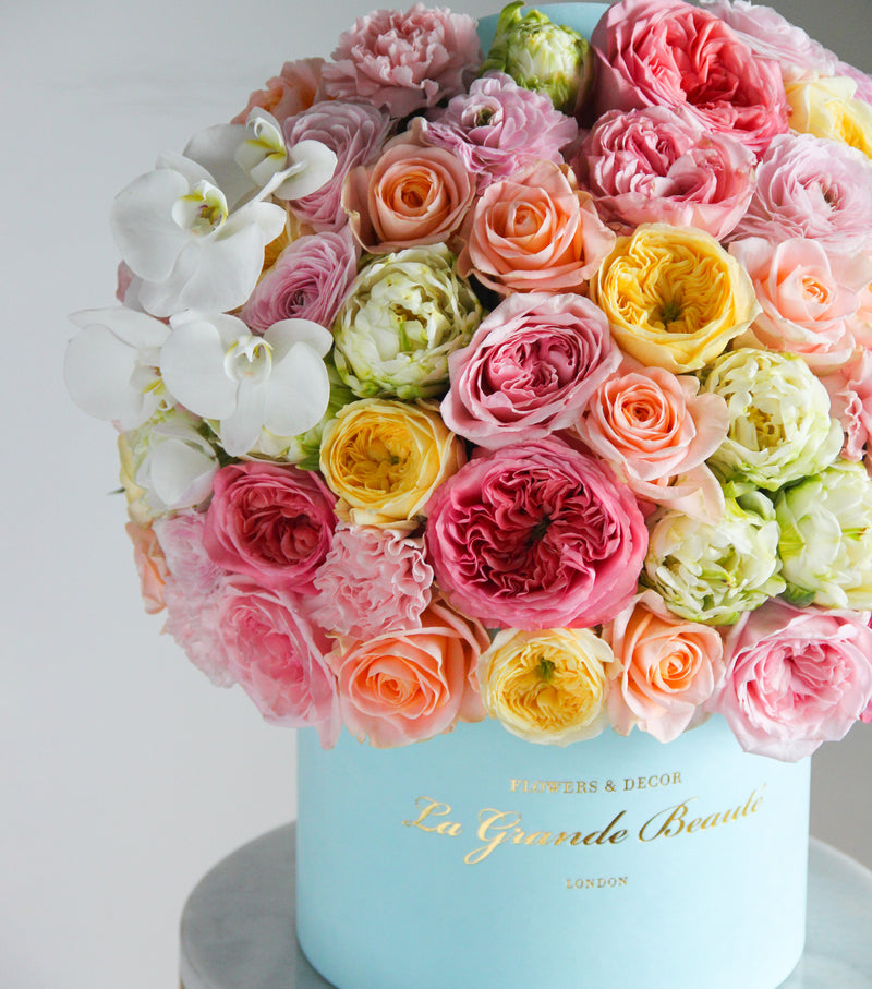 ''Treasure'', freshflowerbox, La Grande Beaute, Fresh, mother, valentines, ''Treasure'' box will definitely make anyone smile. Pink, yellow and peach hue garden and classic roses, ranunculus, orchids, tulips and carnations- all carefully put together with effort and detail. The arrangement in the photo is in the blue 25cm size La Grande Beaute velvet box. Central London Delivery Only. Please check our shipping policies for postcodes. DISCLAIMER - FRESH FLOWERS: These are fresh cut flowers and ar