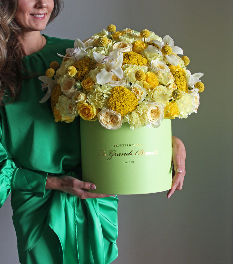 "Sunshine'', freshflowerbox, La Grande Beaute, Fresh, Bring a smile to their faces with this bright, mood-uplifting arrangement. Yellow tone classic, garden and spray roses, carnations, orchids and other flowers are used to create this ''sunny'' box. The arrangement in the photo is in the green 27cm size La Grande Beaute box. Central London Delivery Only. Please check our shipping policies for postcodes. DISCLAIMER - FRESH FLOWERS: These are fresh cut flowers and are perishable