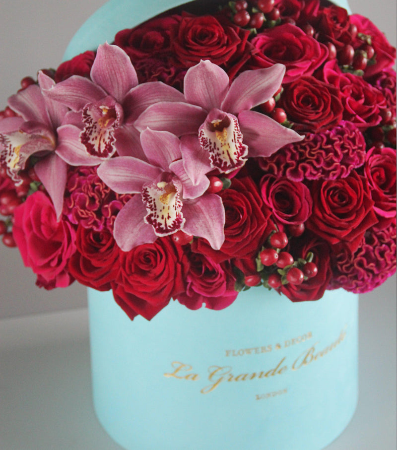 "Rubine", freshflowerbox, La Grande Beaute, Fresh, mother, valentines, This ravishing box "Rubine" is composed of red, pink, coral roses, cockscombs, hypericum berries, and orchids in the velvet La Grande Beaute box. The arrangement in the photo is in the blue velvet 25cm La Grande Beaute box. Central London Delivery Only. Please check our shipping policies for postcodes. DISCLAIMER - FRESH FLOWERS: These are fresh cut flowers and are perishable.Please check "Care & Handling" for how to care for
